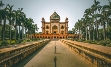 Explore the stunning Safdarjung Tomb in New Delhi, India, surrounded by lush gardens and palm trees.