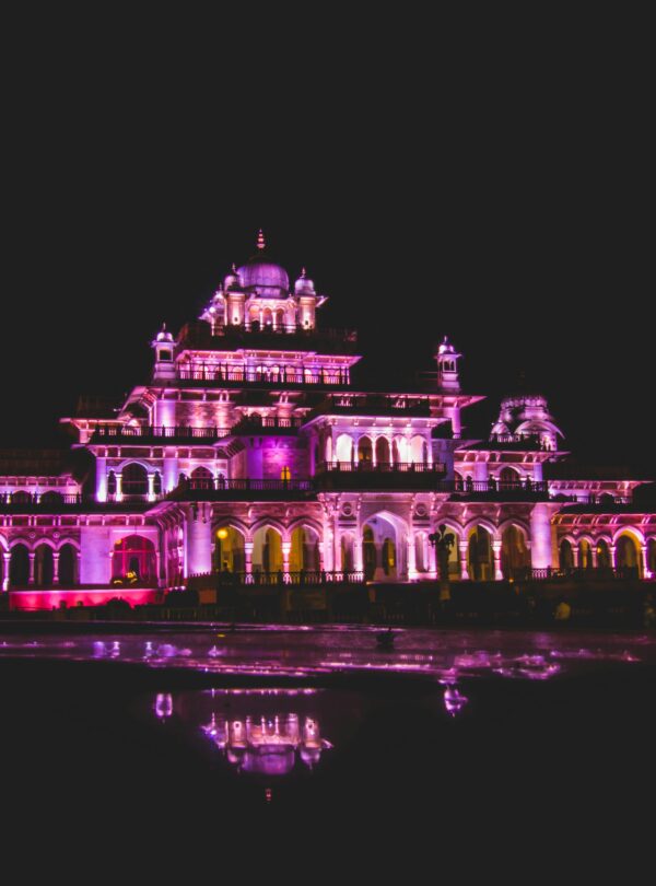 Dazzling illuminated night view of Albert Hall Museum in Jaipur, showcasing its architectural beauty and reflection.