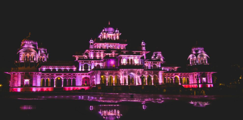 Dazzling illuminated night view of Albert Hall Museum in Jaipur, showcasing its architectural beauty and reflection.