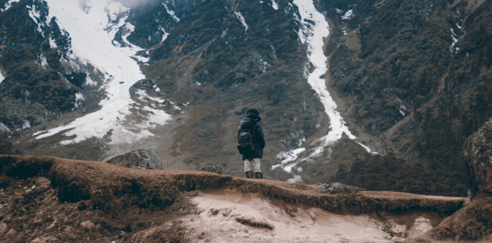 Solo adventurer stands on a rugged ridge in the Himalayan mountains, Gangtok.