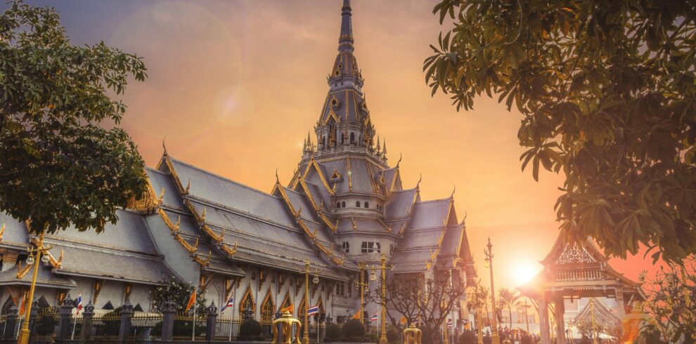 Scenic view of Wat Sothonwararam Temple during sunset in Thailand, capturing its beautiful architecture.