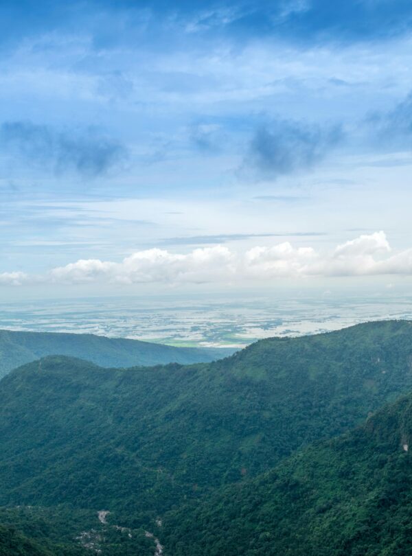 Stunning aerial landscape of lush green mountains and expansive sky, capturing natural beauty and serenity.